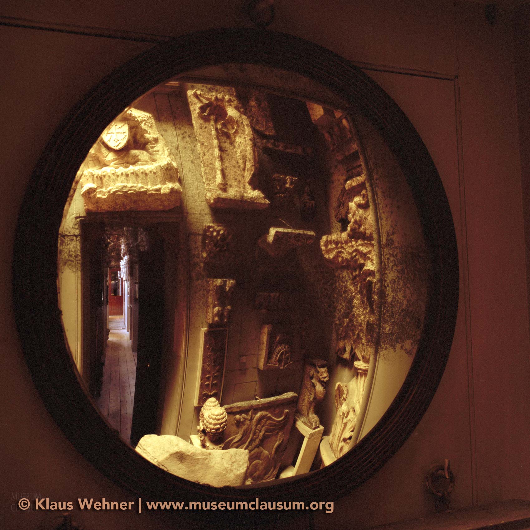 Sir John Soane's Museum: View into a large round convex mirror showing the Museum Corridor.