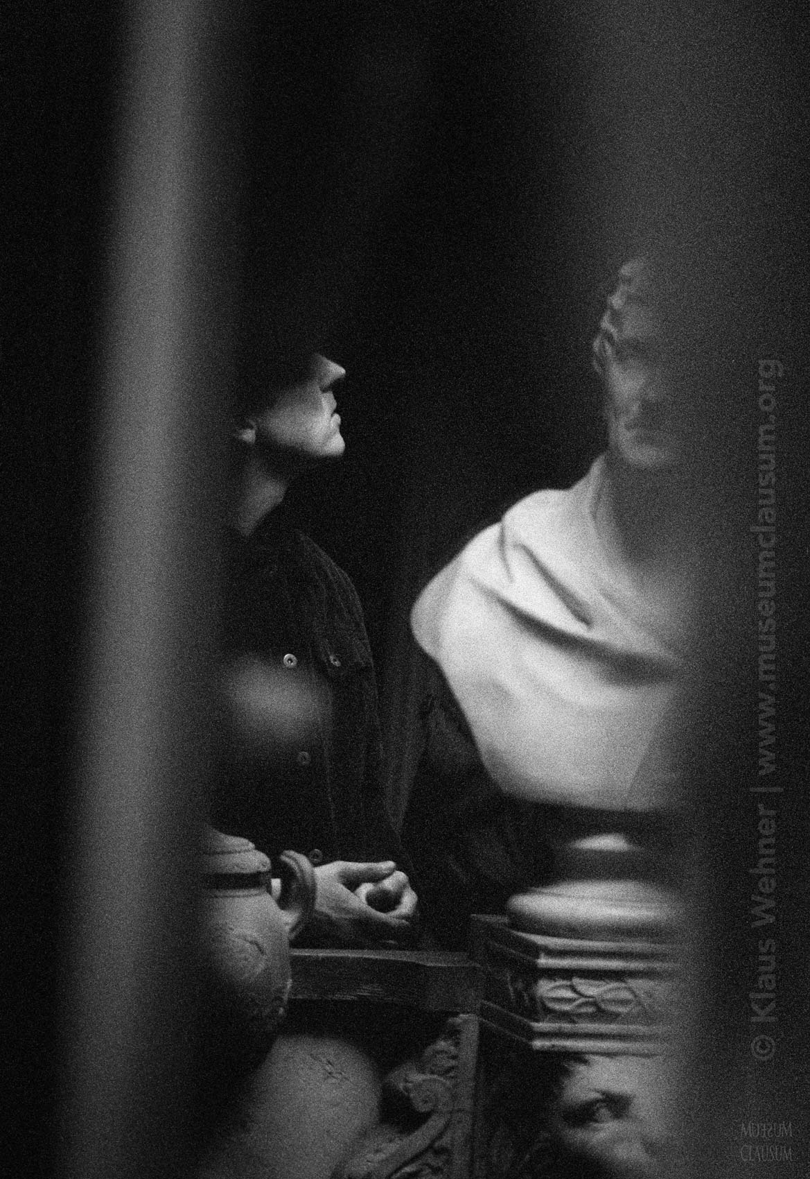 Sir John Soane's Museum: Black and white crop partially showing the Soane bust and a visitor lookin at it.